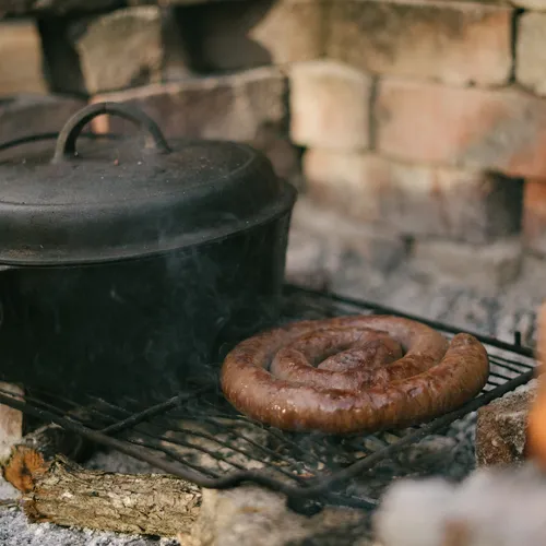 a hot boerewors and a pot on a grill